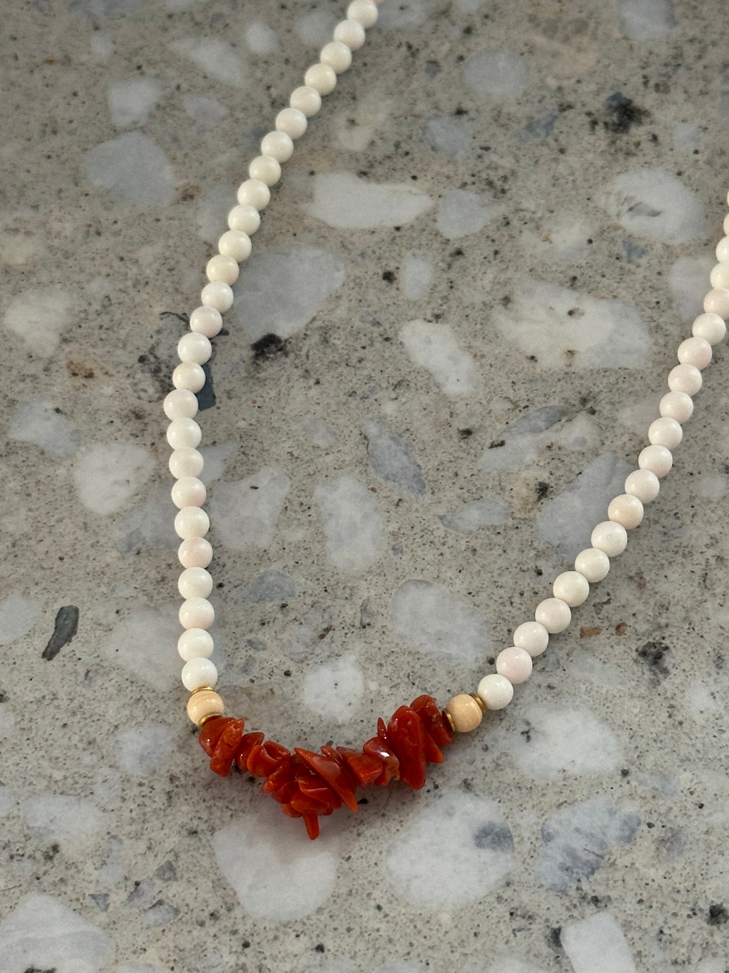 White beaded necklace with coral