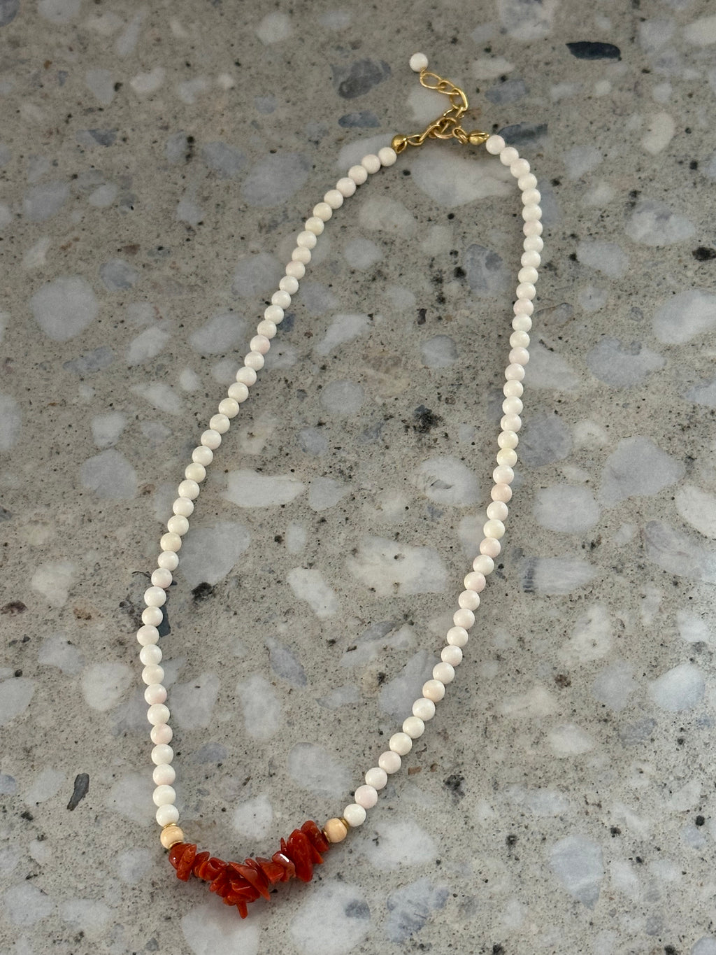 White beaded necklace with coral
