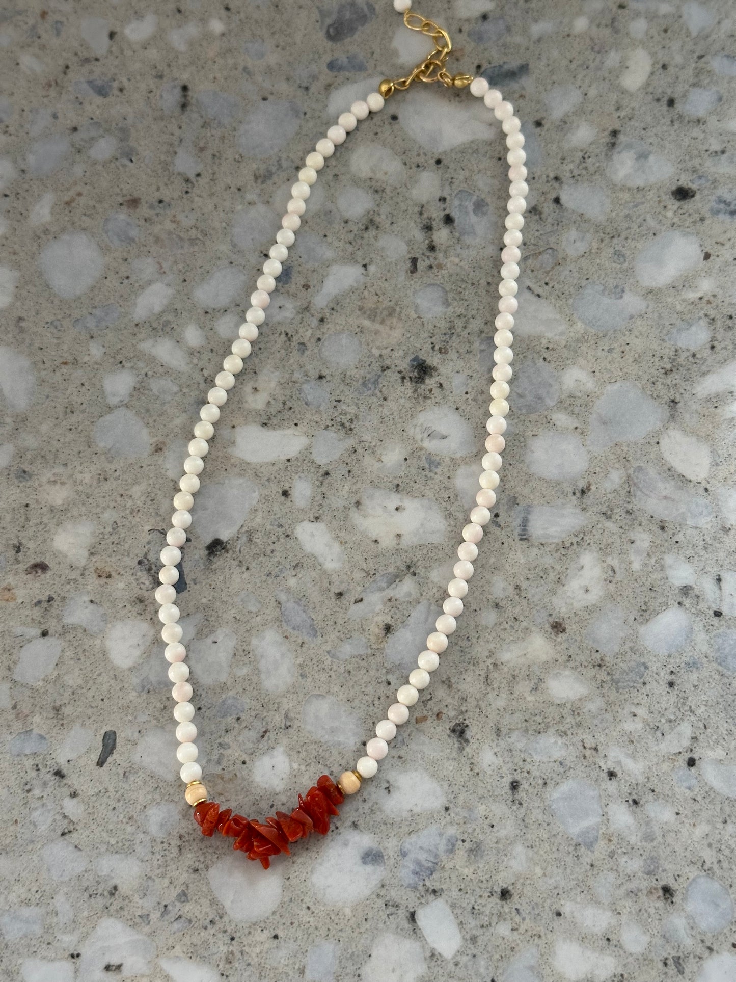 White beaded necklace with coral